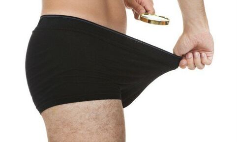 a man looking at his underwear before the penis enlargement pump