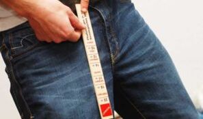 Man measuring penis with ruler